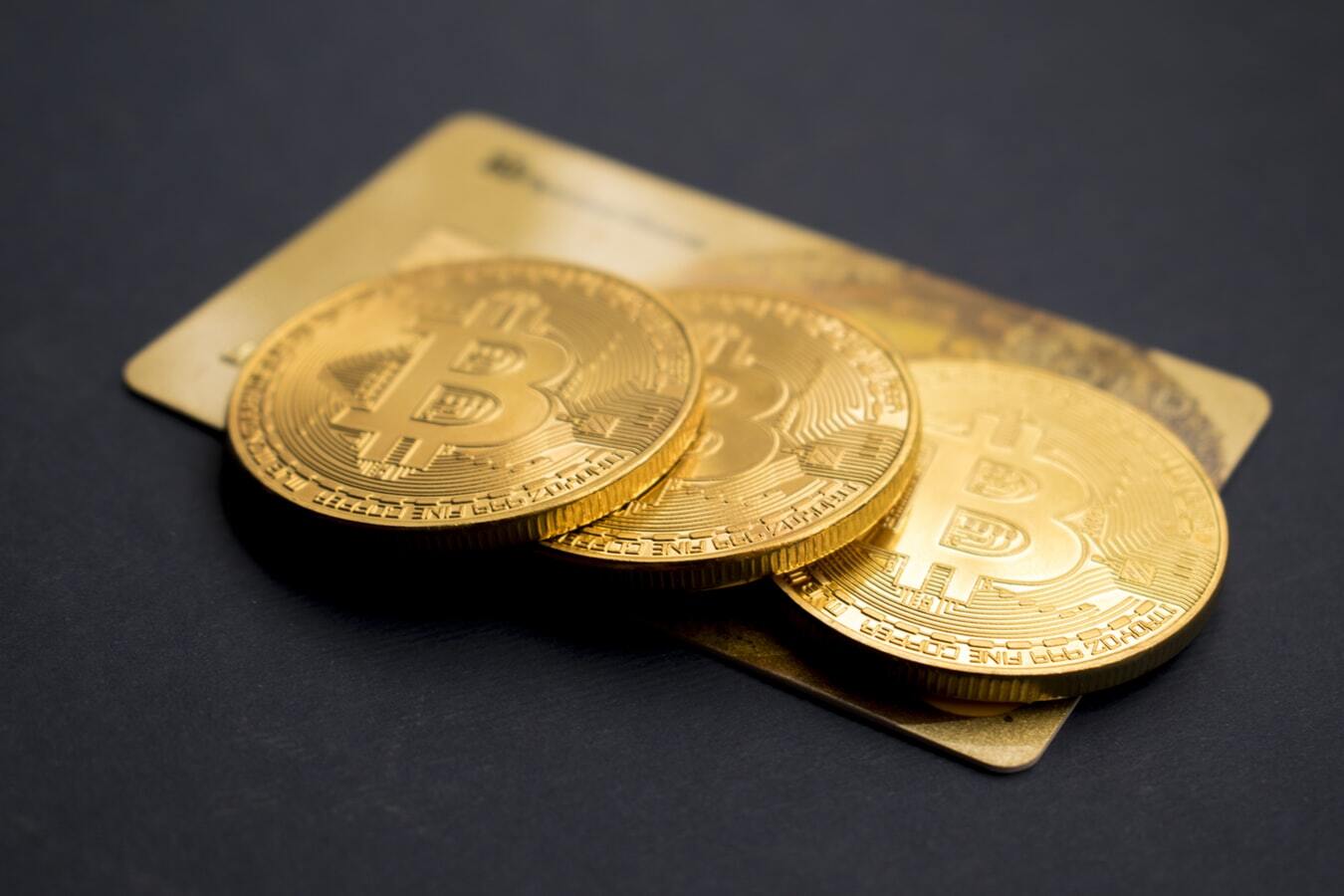 three-bitcoins-on-golden-card-aboutus-page.